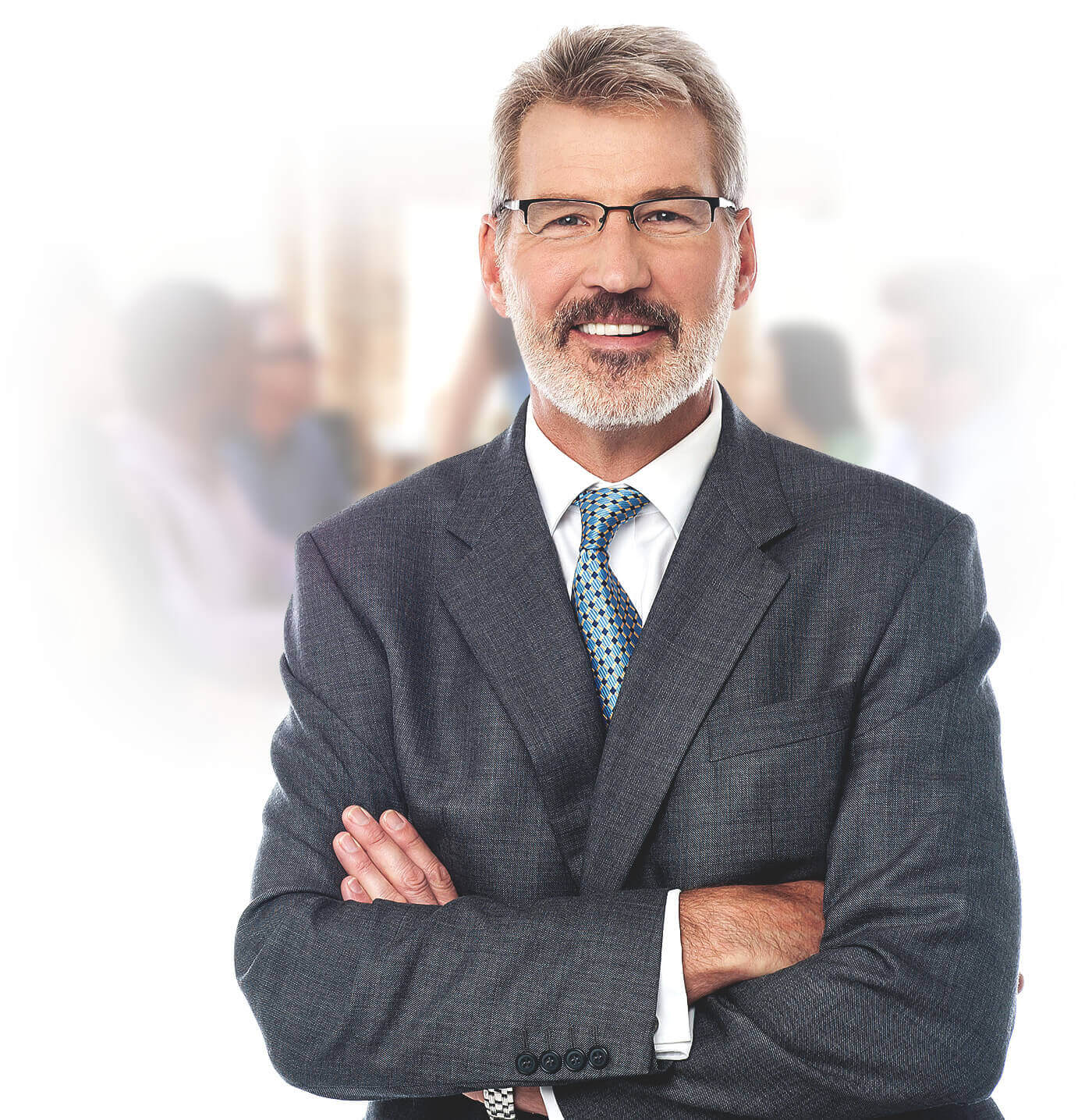 A confident middle-aged businessman wearing glasses and a suit, standing with arms crossed and smiling.