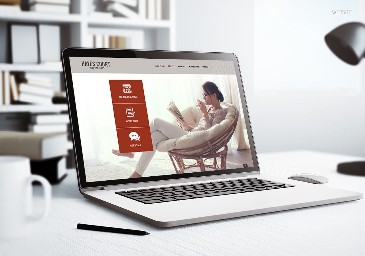 A person sitting comfortably in a chair using a laptop displaying a website with an orange and white interface.