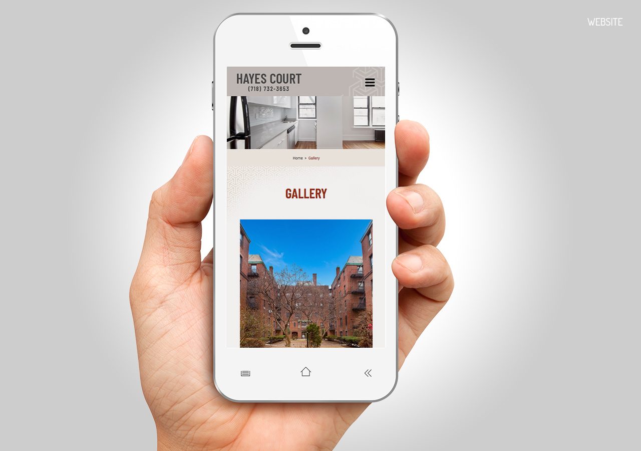 A hand holding a white smartphone displaying a webpage with images and text about a place called Baytex Court.