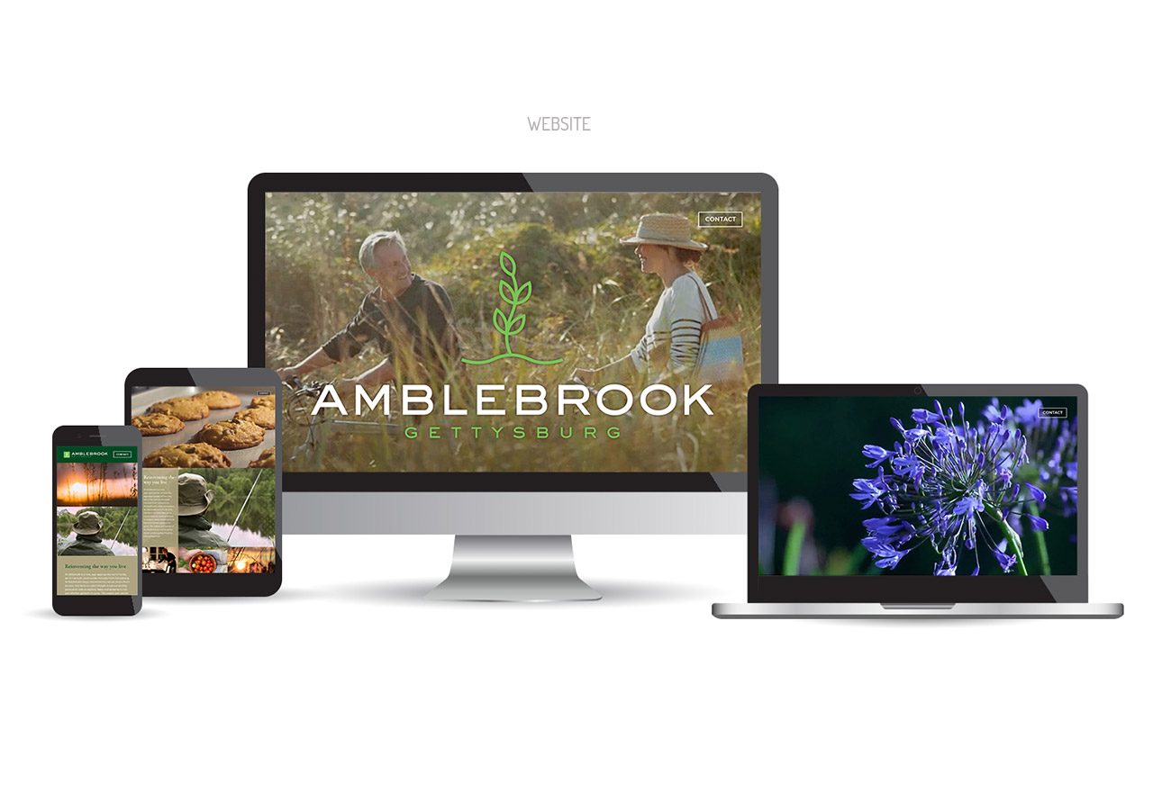 A desktop computer and a tablet displaying the Amblebrook website with images of food, flowers, and people outdoors.