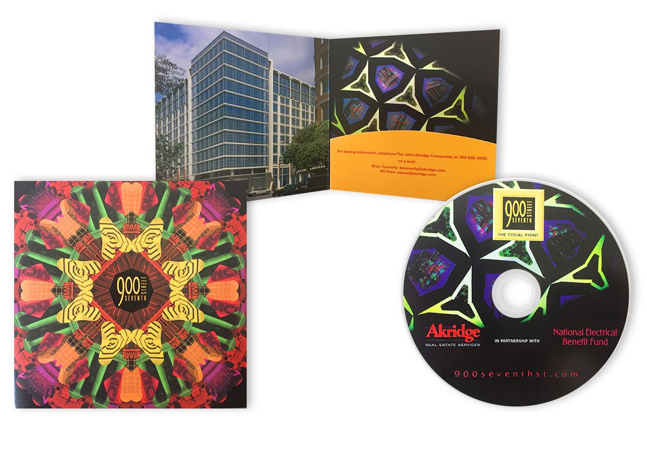 A colorful CD package featuring a vibrant kaleidoscope design and a black CD with a star pattern on the cover and disc.