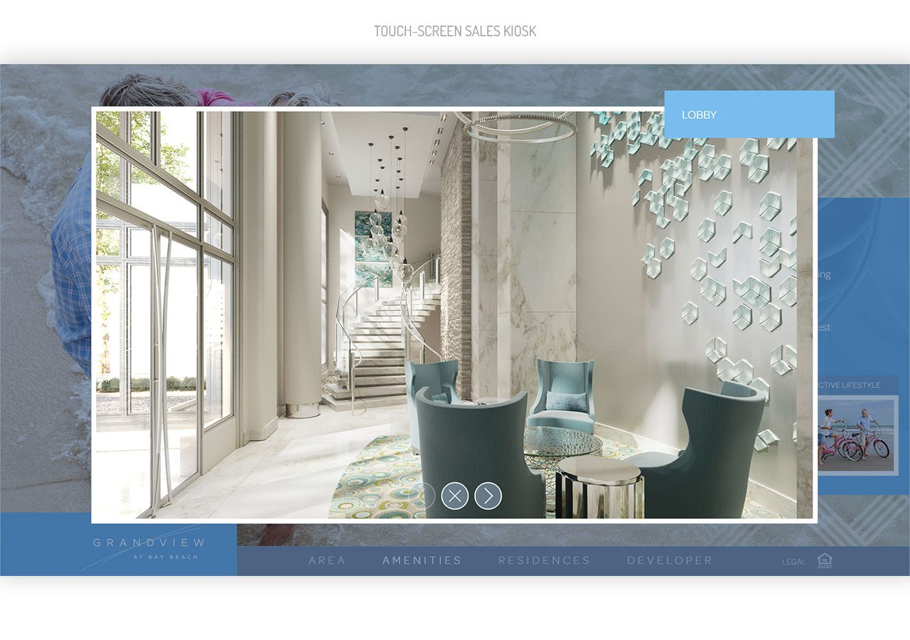 Modern office lobby with large windows, two gray chairs, and decorative hanging lights and wall art.
