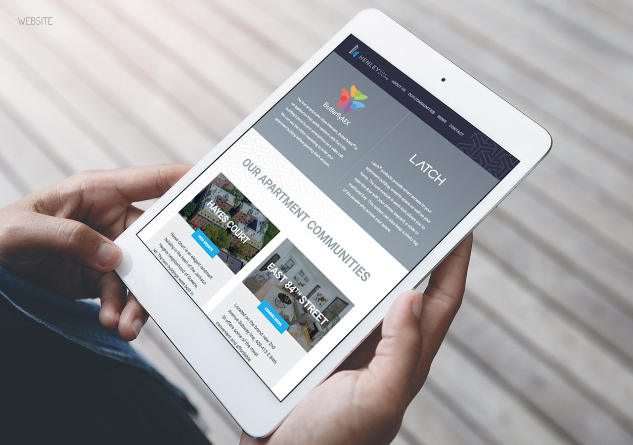 Person holding a tablet displaying a webpage about a service company with images and text sections.