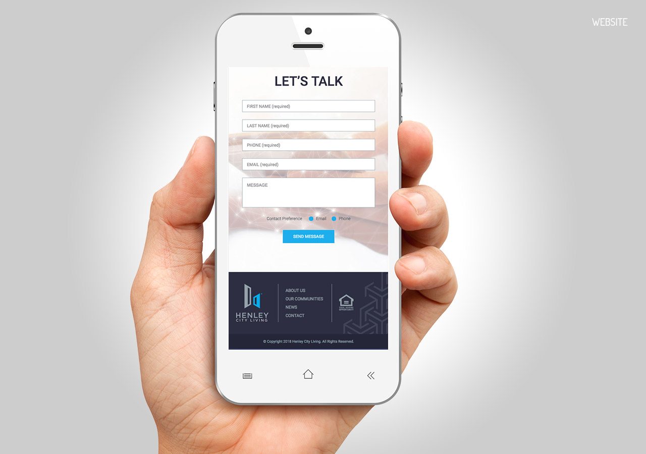 A hand holding a white smartphone displaying a contact form with 'LET'S TALK' header and social media icons below.
