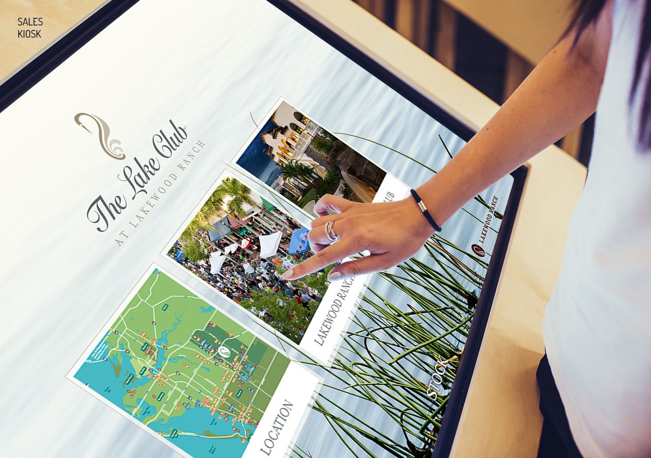 A person placing a ring on a photo in a wedding guest book with pictures and a map.