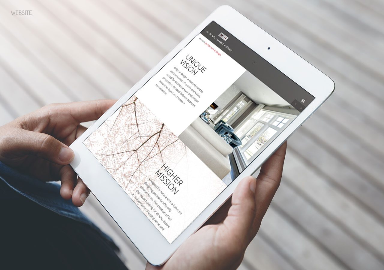 Person holding a tablet displaying a modern real estate listing with images and property details.