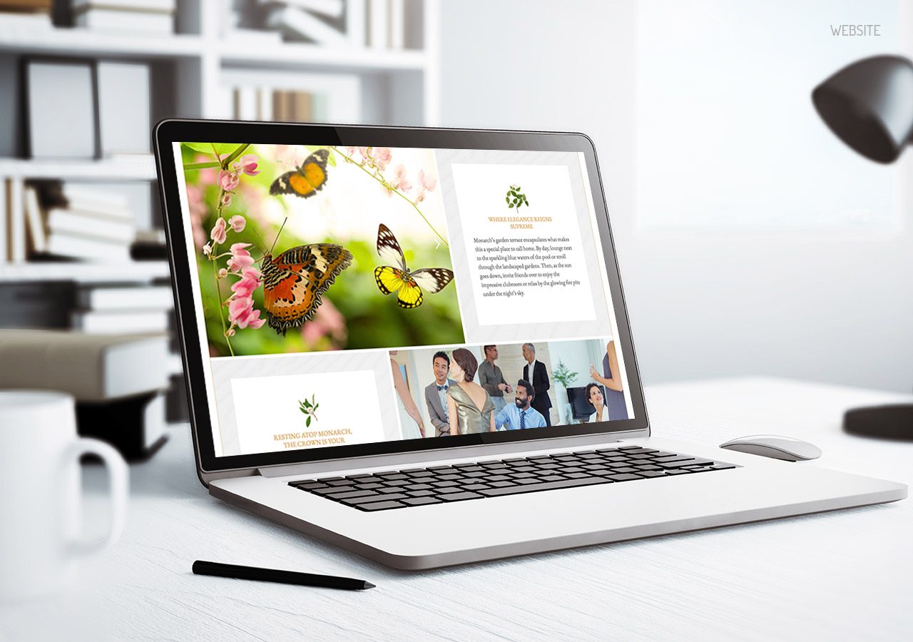 A laptop on a desk displays a vibrant website featuring butterflies, flowers, and a team photo, alongside office supplies.