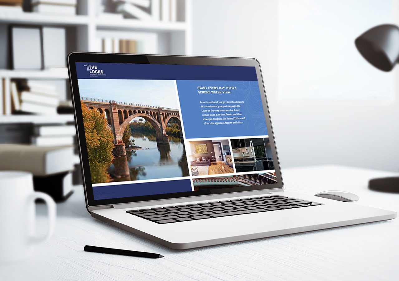 A laptop displaying a website with an image of a bridge and text on a desk with a pen nearby.